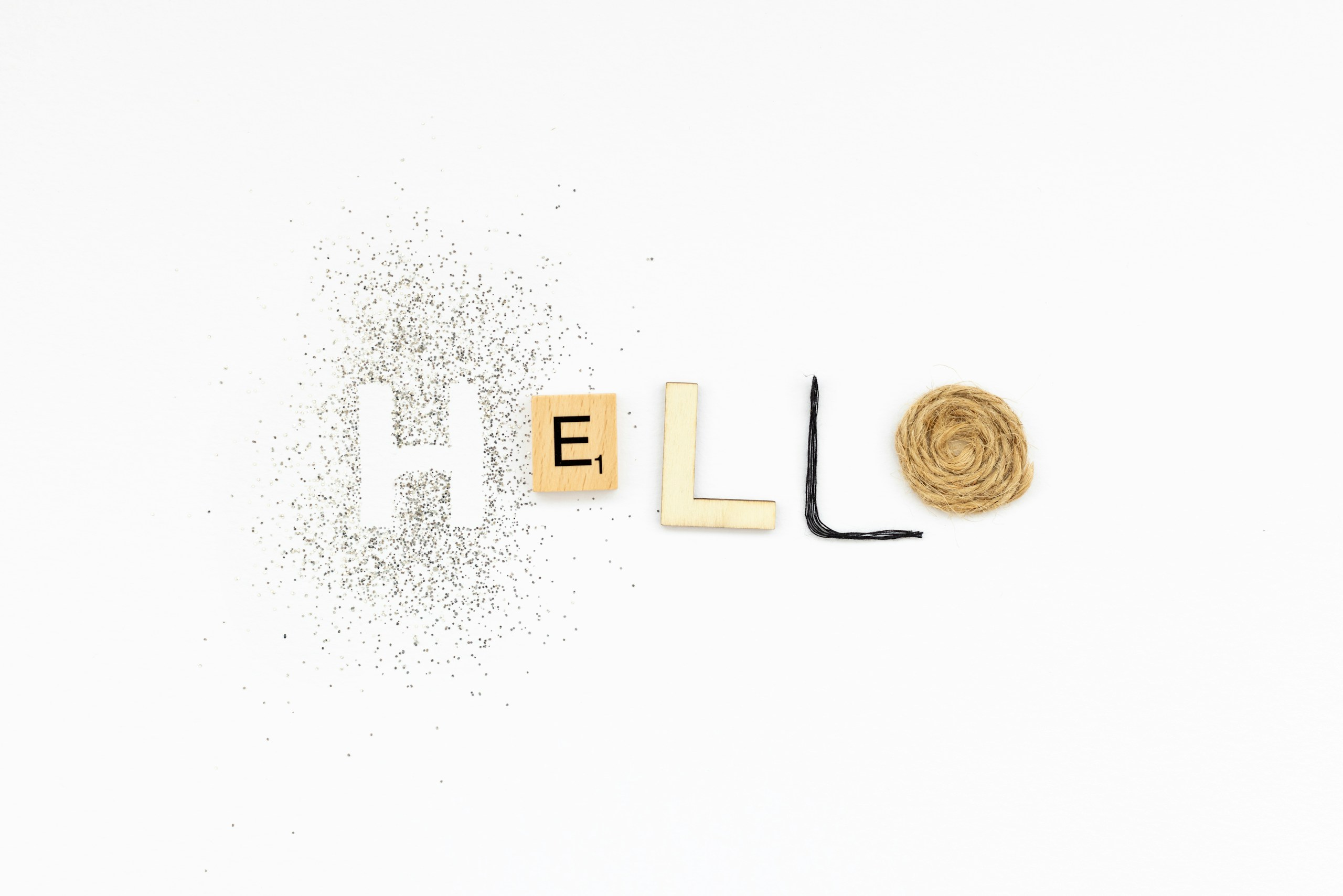 The word 'HELLO' spelled out in mixed letters on a white background, with negative space around.